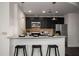 Modern kitchen featuring a breakfast bar with granite countertop and stainless steel appliances at 943 Peachtree Ne St # 1108, Atlanta, GA 30309