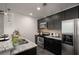 Modern kitchen with stainless steel appliances, black cabinets, and granite countertops at 943 Peachtree Ne St # 1108, Atlanta, GA 30309