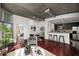 Open-concept living area with concrete ceilings, wood floors, and modern kitchen with breakfast bar at 943 Peachtree Ne St # 1108, Atlanta, GA 30309
