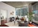 Bright living room with hardwood floors, stylish furniture, and large windows showcasing city views at 943 Peachtree Ne St # 1108, Atlanta, GA 30309