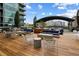 Stylish rooftop terrace featuring wood flooring, outdoor seating, a covered dining area, and skyline views at 943 Peachtree Ne St # 1108, Atlanta, GA 30309