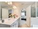Bathroom boasts double sinks, white cabinets, and a view into the bedroom at 10166 Benton Woods Dr, Covington, GA 30014
