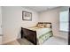 Bedroom with neutral decor and a large window at 10166 Benton Woods Dr, Covington, GA 30014