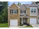 Charming townhome showcasing brick facade, front lawn and attached single-car garage at 10166 Benton Woods Dr, Covington, GA 30014