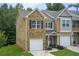 Charming townhome showcasing brick facade, front lawn and attached single-car garage at 10166 Benton Woods Dr, Covington, GA 30014