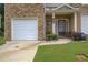 Home featuring single-car garage, walkway, front lawn and manicured landscaping at 10166 Benton Woods Dr, Covington, GA 30014