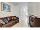 Hallway with a leather sofa, neutral walls, wood-look floors, and recessed lighting at 10166 Benton Woods Dr, Covington, GA 30014