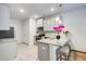 Well-lit kitchen offers a granite countertop island with barstool seating and stainless steel appliances at 10166 Benton Woods Dr, Covington, GA 30014
