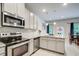 Charming kitchen features a functional layout with stainless appliances and a peninsula counter overlooking the dining area at 10166 Benton Woods Dr, Covington, GA 30014