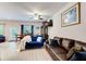 Open-concept living room featuring wood-look flooring, fan, and large windows for natural light at 10166 Benton Woods Dr, Covington, GA 30014