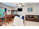 Open-concept living room with a dining area featuring wood-look flooring and a ceiling fan at 10166 Benton Woods Dr, Covington, GA 30014