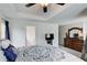 Comfortable main bedroom with a tray ceiling, plush carpet, and view of the ensuite bath at 10166 Benton Woods Dr, Covington, GA 30014