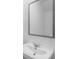 A bathroom sink features chrome fixtures and a sleek, modern gray mirror at 1420 Windance Lake Dr, Loganville, GA 30052