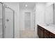 New construction bathroom featuring dark cabinets, shower, and a walk-in closet at 1420 Windance Lake Dr, Loganville, GA 30052