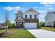 Charming two-story home featuring stone accents, a two-car garage, and a well-manicured front lawn at 1420 Windance Lake Dr, Loganville, GA 30052