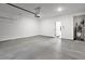 Spacious two-car garage with concrete floors, overhead lighting, and access to the inside at 1420 Windance Lake Dr, Loganville, GA 30052