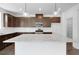 Spacious kitchen with granite counters, stainless appliances, dark wood cabinets, and a large island at 1420 Windance Lake Dr, Loganville, GA 30052