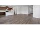 Open concept living area connecting a modern kitchen and featuring wood floors and white walls at 1420 Windance Lake Dr, Loganville, GA 30052