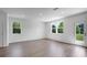 Bright, open living room featuring hardwood floors, white walls, and sliding door to the back yard at 1420 Windance Lake Dr, Loganville, GA 30052