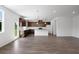 Open concept living area with hardwood floors, connecting to kitchen, offering lots of natural light at 1420 Windance Lake Dr, Loganville, GA 30052