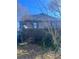 View of a home's backyard with mature trees and a fence at 1483 Hardee Ne St, Atlanta, GA 30307