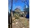 View of home's exterior with trees and overgrown backyard at 1483 Hardee Ne St, Atlanta, GA 30307