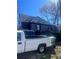 Residential home featuring a gable roof, truck in driveway and a fenced yard at 1483 Hardee Ne St, Atlanta, GA 30307