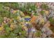 Aerial view of the home nestled among colorful trees, showcasing its private setting at 3465 Callie Still Rd, Lawrenceville, GA 30045