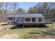 Spacious backyard featuring a large deck with outdoor seating and a grill at 3465 Callie Still Rd, Lawrenceville, GA 30045
