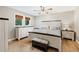 Well-lit bedroom with wood floors and a white paneled bed frame complemented by matching dressers and nightstands at 3465 Callie Still Rd, Lawrenceville, GA 30045