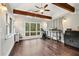 Spacious bonus room with exposed beams, hardwood floors, and ample natural light at 3465 Callie Still Rd, Lawrenceville, GA 30045