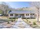 Charming home featuring a welcoming front porch, tidy landscaping, and a stone walkway leading to the entrance at 3465 Callie Still Rd, Lawrenceville, GA 30045