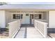 Charming front porch with a light blue door, white railing, and a 'HELLO' sign, offering a welcoming and inviting feel at 3465 Callie Still Rd, Lawrenceville, GA 30045