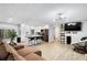 Open-concept living room with modern lighting, sleek floors, and a seamless flow into the kitchen area at 3465 Callie Still Rd, Lawrenceville, GA 30045