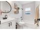 Bright bathroom featuring a shower-tub combo, shiplap accent wall, and modern fixtures at 1060 Mclinden Se Ave, Smyrna, GA 30080