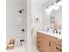 Modern bathroom with neutral accents, soaking tub and black plumbing fixtures at 1060 Mclinden Se Ave, Smyrna, GA 30080