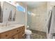 Modern bathroom with a glass shower, mosaic tile floor, and a wood vanity with a marble countertop at 1060 Mclinden Se Ave, Smyrna, GA 30080