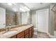Well-lit bathroom featuring double sinks, granite countertop, and a tiled shower/tub combo at 200 River Vista Dr # 205, Atlanta, GA 30339