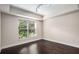 Bright and spacious bedroom with a large window and hardwood floors at 200 River Vista Dr # 205, Atlanta, GA 30339