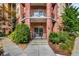 Exterior building view with brick facade and private balcony with a black metal fence at 200 River Vista Dr # 205, Atlanta, GA 30339