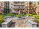 Landscaped courtyard with paved walkway and seating areas at 200 River Vista Dr # 205, Atlanta, GA 30339