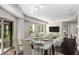 Bright dining room with large windows, a glass dining table, and an open concept to the living room at 200 River Vista Dr # 205, Atlanta, GA 30339