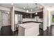 Modern kitchen with stainless steel appliances, granite countertops, dark wood cabinets and an island at 200 River Vista Dr # 205, Atlanta, GA 30339