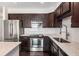 Updated kitchen features stainless steel appliances, dark wood cabinets, marble countertops, and a stylish backsplash at 200 River Vista Dr # 205, Atlanta, GA 30339