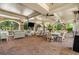 Covered outdoor patio with ample seating, ceiling fans, and a mounted television at 200 River Vista Dr # 205, Atlanta, GA 30339