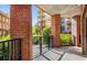 Patio featuring brick columns, black metal railing, and views of a grassy courtyard at 200 River Vista Dr # 205, Atlanta, GA 30339