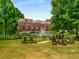 Picturesque pond with fountain and chairs with townhouse building in the background at 200 River Vista Dr # 205, Atlanta, GA 30339