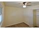 Well-lit bedroom featuring a ceiling fan, closet, neutral walls, and wood-look floors; window provides ample natural light at 2422 Clarissa Nw Dr, Atlanta, GA 30318