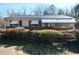 Charming one-story home with neutral siding, awnings, and mature landscaping at 2422 Clarissa Nw Dr, Atlanta, GA 30318
