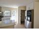 Eat-in kitchen with modern stainless refrigerator, light hardwood floors, and quartz island at 2422 Clarissa Nw Dr, Atlanta, GA 30318
